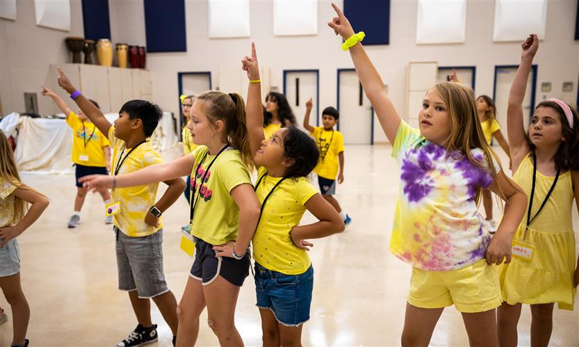 Students dance in a classroom
